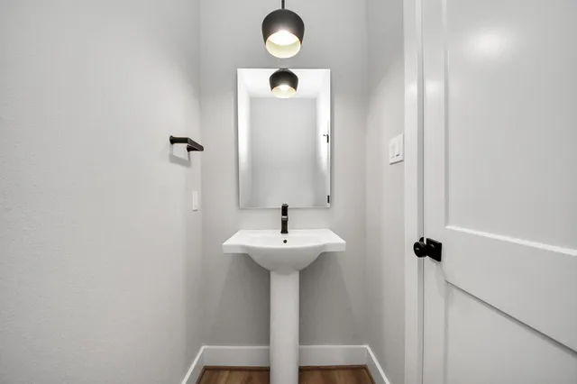 a bathroom with a sink a mirror and shower
