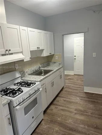 a kitchen with stainless steel appliances granite countertop a stove and a sink