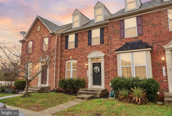 a front view of a house with yard and green space