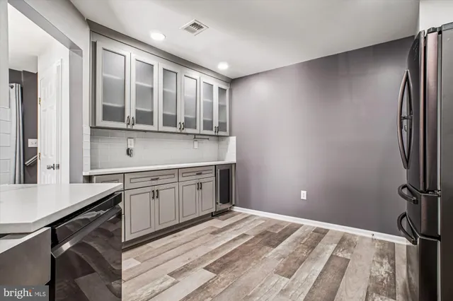 a kitchen with a refrigerator and a sink