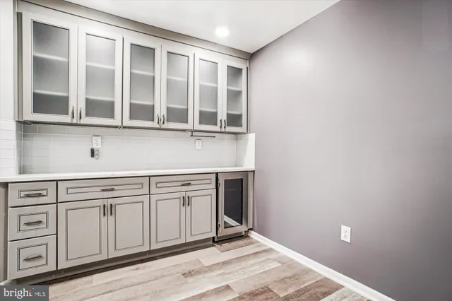 a view of a kitchen with cabinets and wooden floor