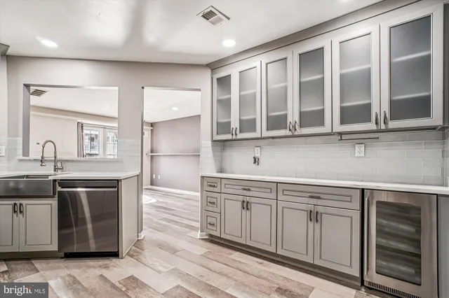 a kitchen with stainless steel appliances granite countertop a sink and cabinets