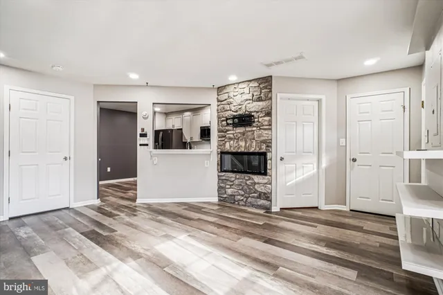 a view of a kitchen with wooden floor and a refrigerator