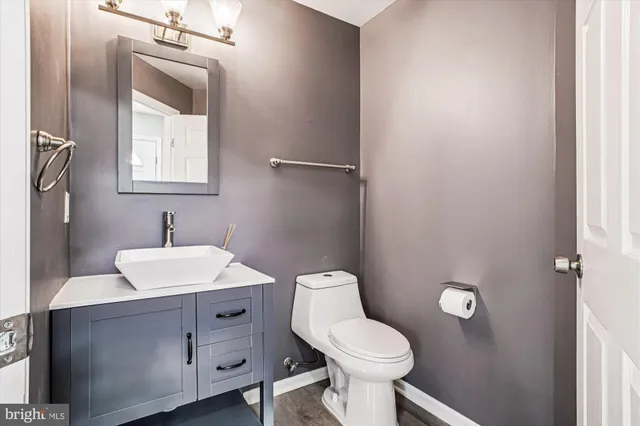 a bathroom with a toilet sink and mirror