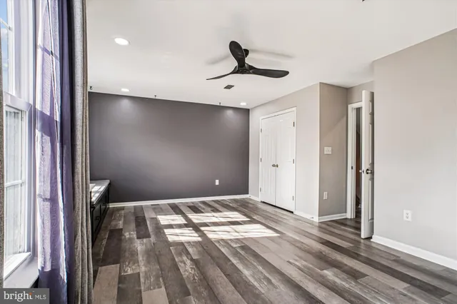 a view of empty room with wooden floor