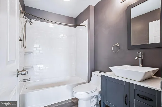 a bathroom with a sink a toilet and a bathtub