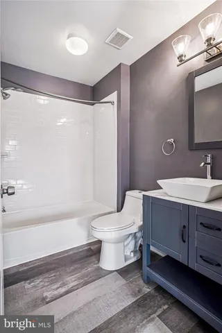 a bathroom with a sink a toilet and a bathtub