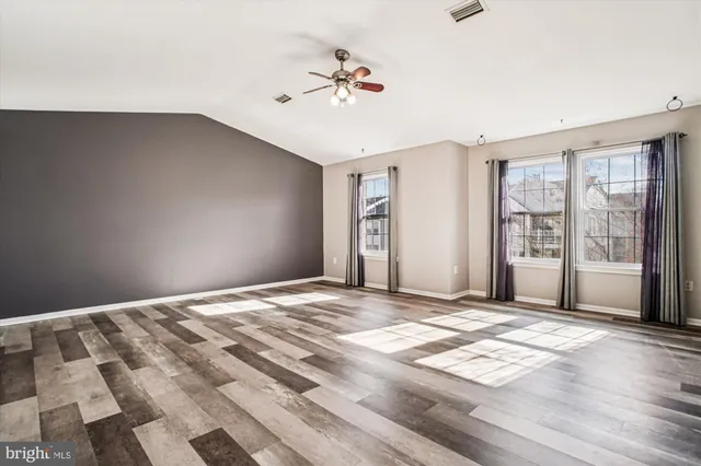 a view of a livingroom with a ceiling fan and window