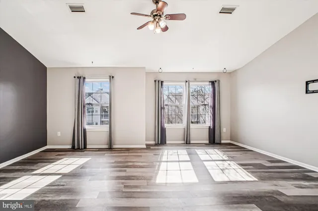 wooden floor in an empty room with a window