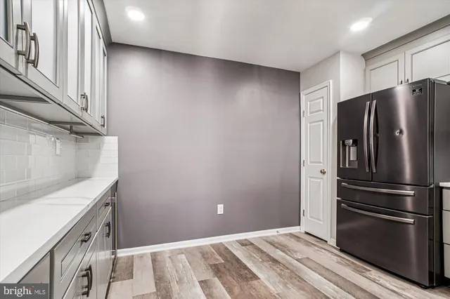 a kitchen with a refrigerator and a sink