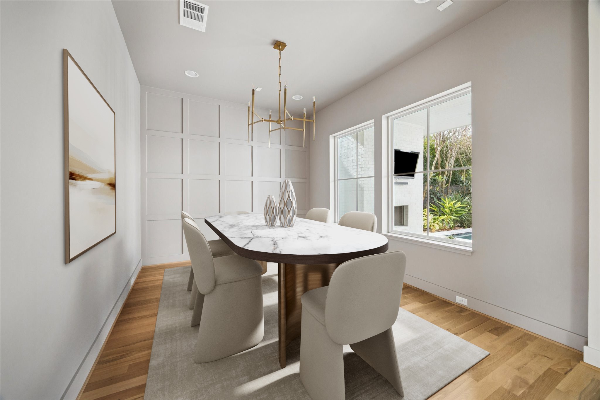4219 Alba Road Houston, TX 77018 - Photo 11 of 37 Stunning dining room featuring custom paneled accent wall, designer chandelier, hardwood floors, and large windows overlooking the backyard. *virtually staged*