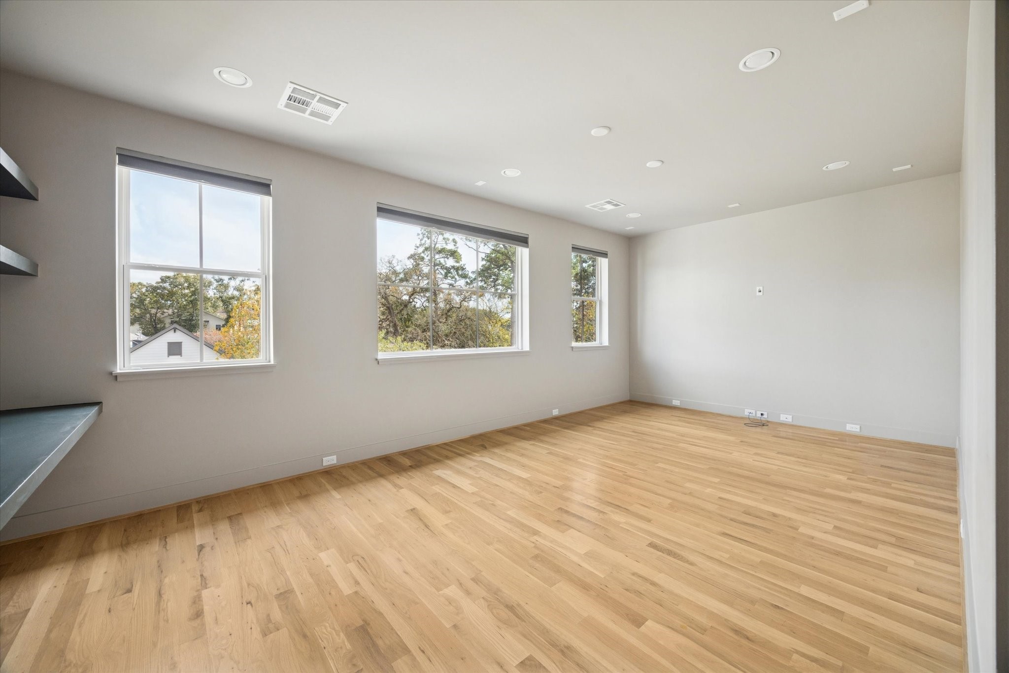 4219 Alba Road Houston, TX 77018 - Photo 18 of 37 a view of an empty room with wooden floor and a window