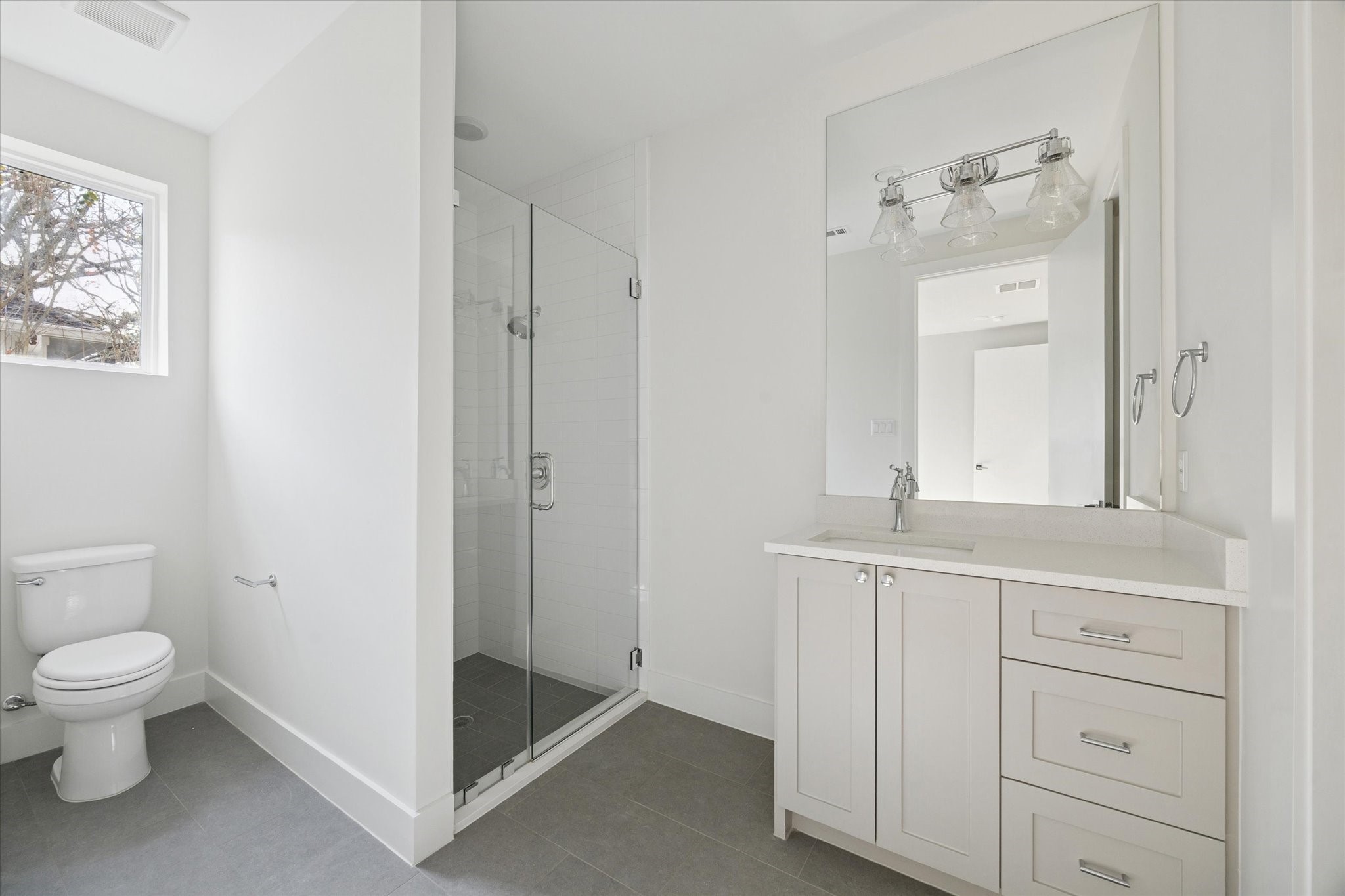 4219 Alba Road Houston, TX 77018 - Photo 29 of 37 a spacious bathroom with a toilet sink and a mirror