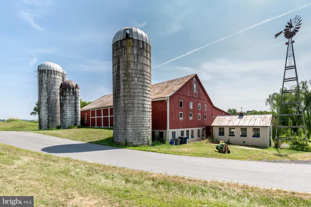 a front view of a house with a garden and plants