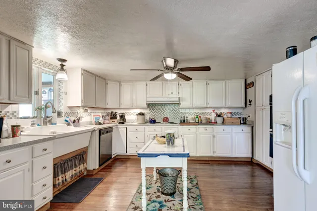 a kitchen with a sink cabinets and refrigerator