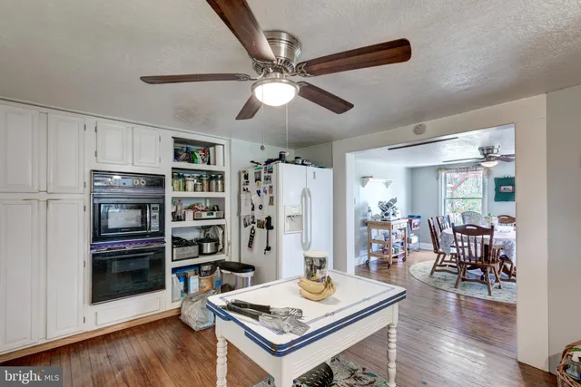 a bedroom with a bed couch and a window