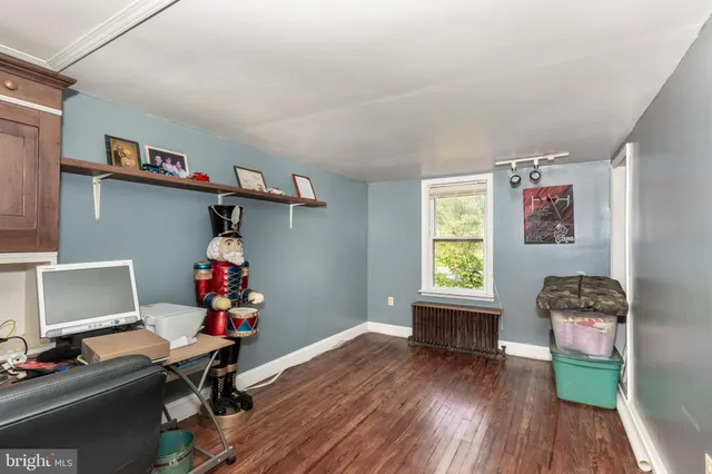 a view of a kitchen with refrigerator and window