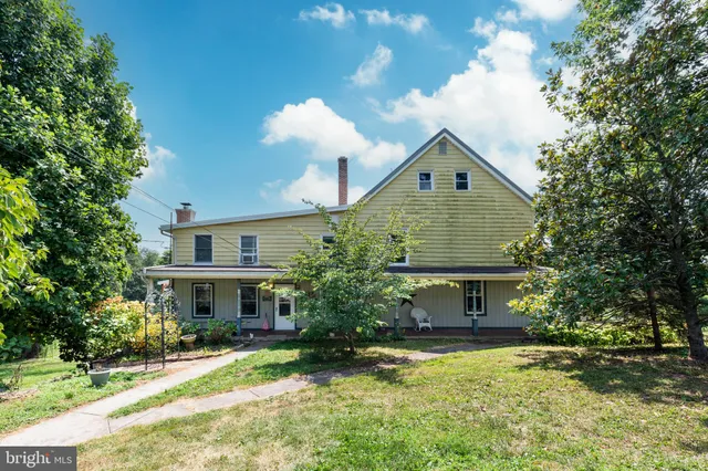 a front view of house with yard and trees