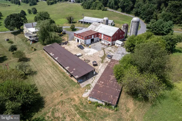 an aerial view of a house with garden space and street view