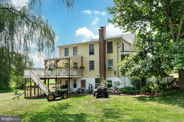 a view of a house with backyard and sitting area