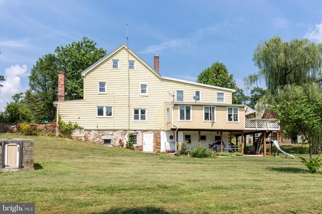 a view of a house with a yard balcony and sitting area