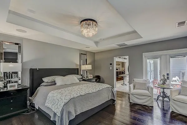 a bedroom with a bed and a chandelier