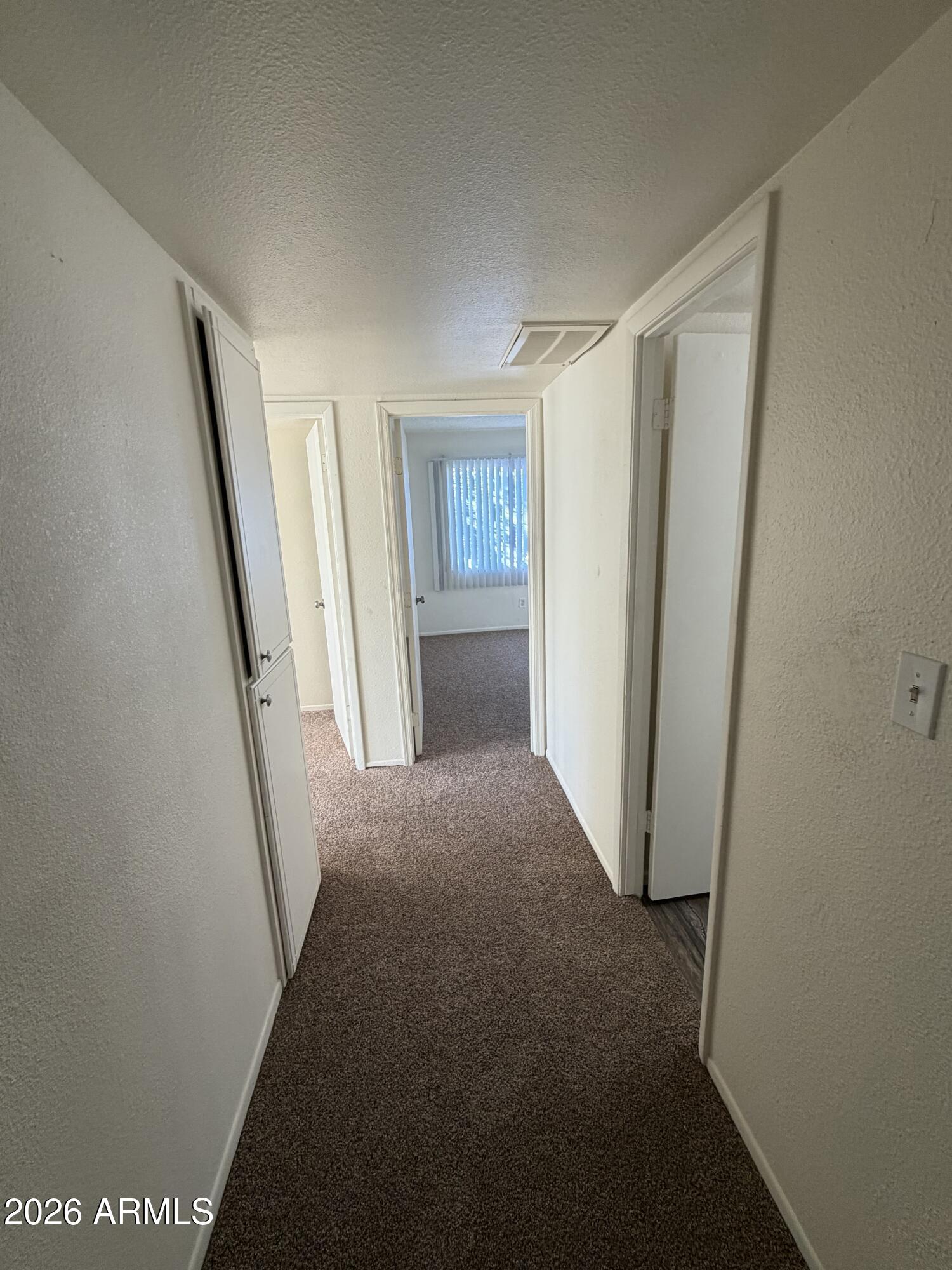 6817 West Devonshire Avenue Phoenix, AZ 85033 - Photo 5 of 11 a view of hallway with window and stairs