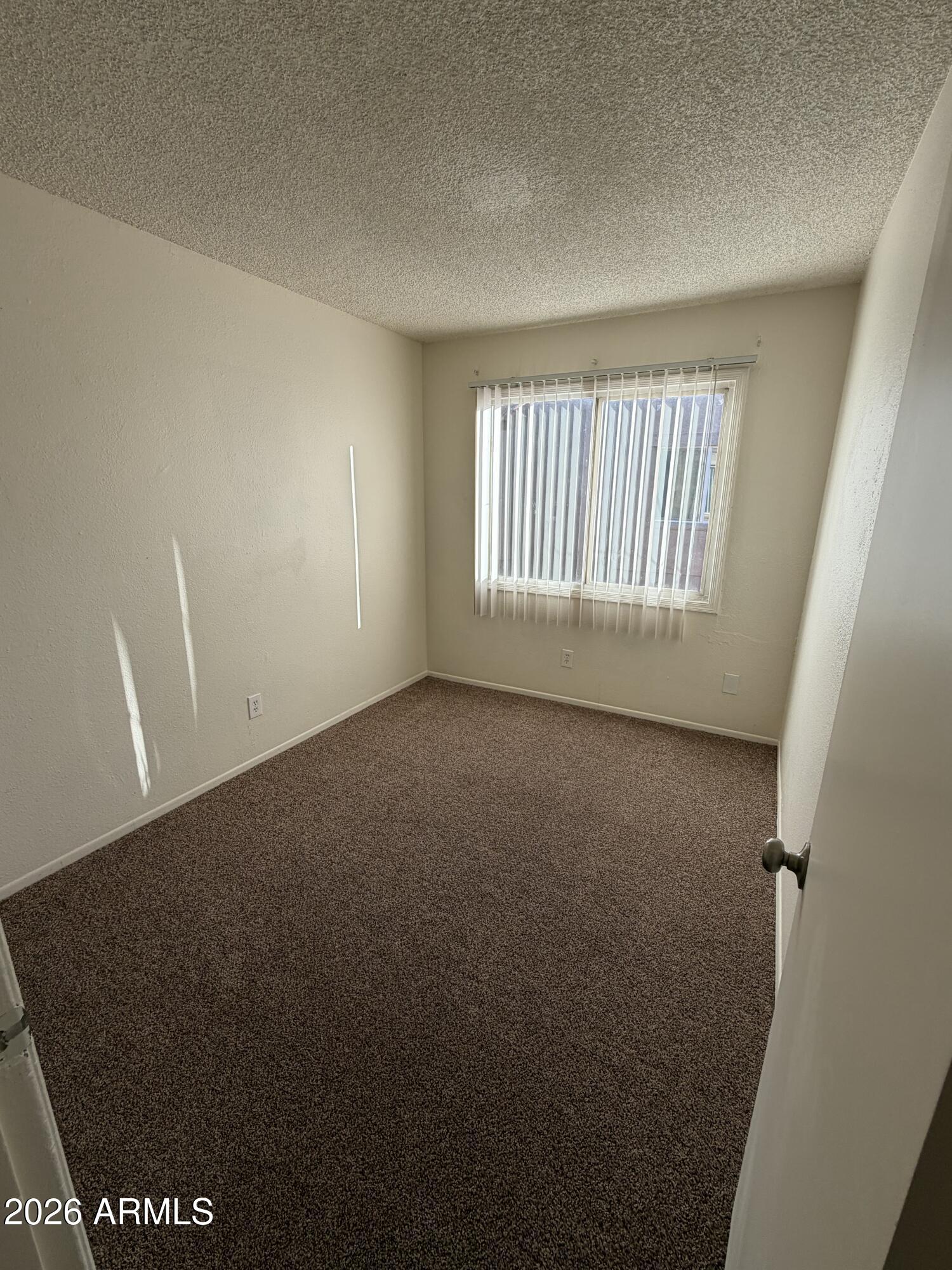 6817 West Devonshire Avenue Phoenix, AZ 85033 - Photo 8 of 11 an empty room with windows
