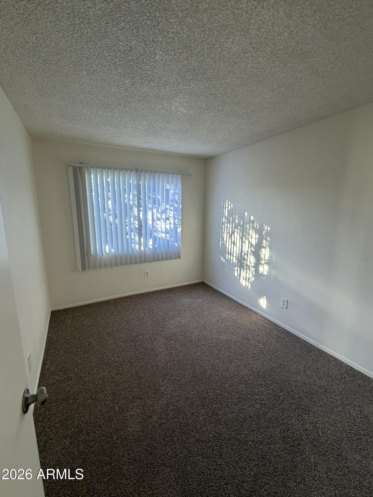 6817 West Devonshire Avenue Phoenix, AZ 85033 - Photo 9 of 11 a view of an empty room with a window