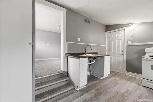 a kitchen with a refrigerator and a stove