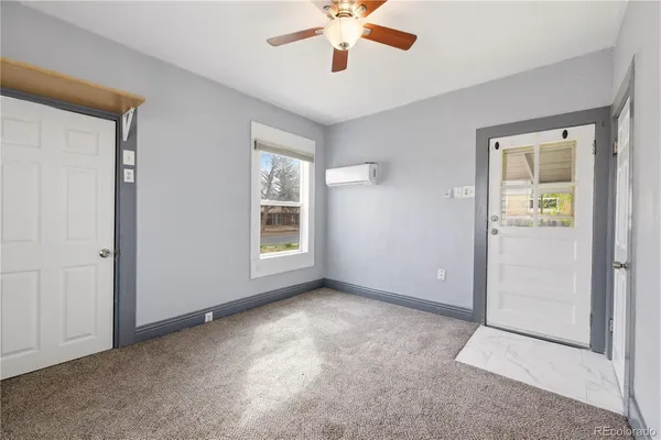 an empty room with windows and closet