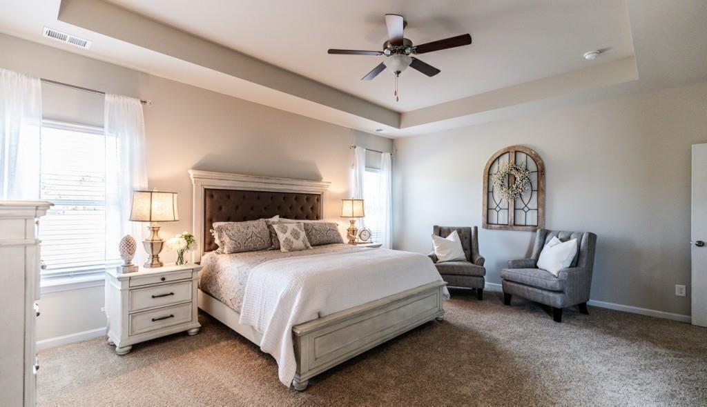 1234 Saddle Ridge Trail Calhoun, GA 30701 - Photo 14 of 18 a bedroom with a bed a chandelier and a couch