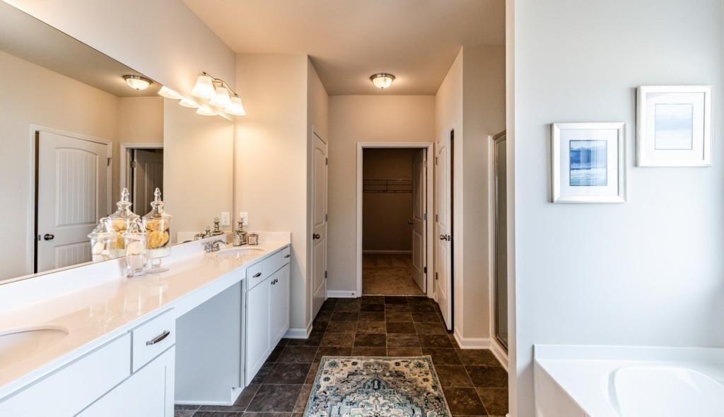 1234 Saddle Ridge Trail Calhoun, GA 30701 - Photo 15 of 18 a bathroom with a double vanity sink a mirror and a bathtub
