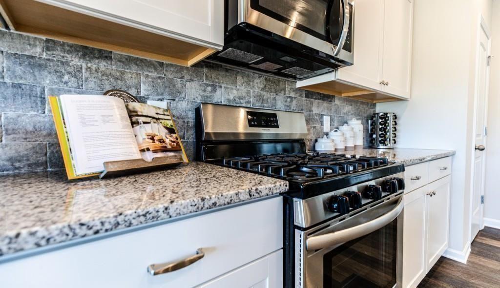 1234 Saddle Ridge Trail Calhoun, GA 30701 - Photo 4 of 18 a kitchen with stainless steel appliances granite countertop a stove and a microwave