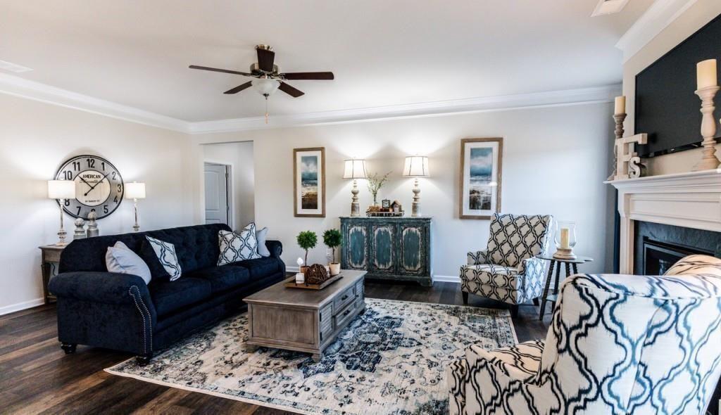1234 Saddle Ridge Trail Calhoun, GA 30701 - Photo 9 of 18 a living room with furniture a fireplace and a flat screen tv