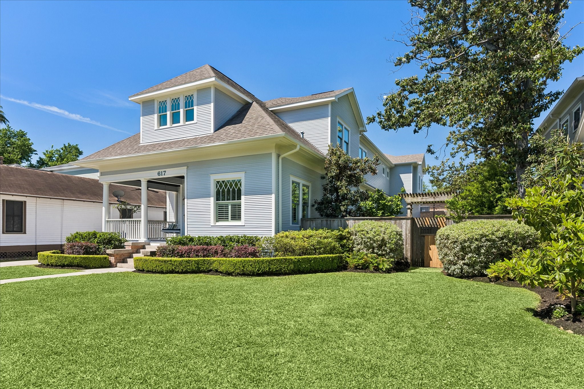 617 Harvard Street Houston, TX 77007 - Photo 2 of 39 a front view of a house with a garden and plants