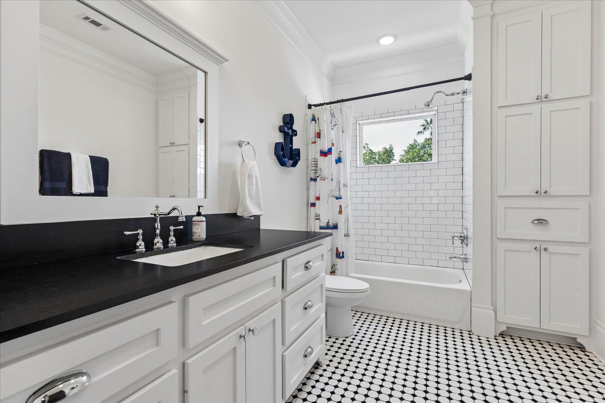 617 Harvard Street Houston, TX 77007 - Photo 28 of 39 a bathroom with a double vanity sink a toilet a shower and a mirror