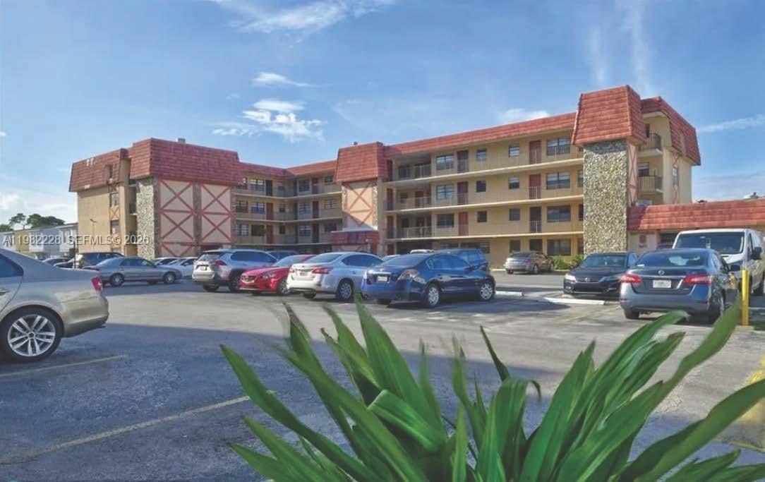 1325 West 68th Street, Unit 113 Hialeah, FL 33014 - Photo 11 of 14 a view of a car park in front of a building