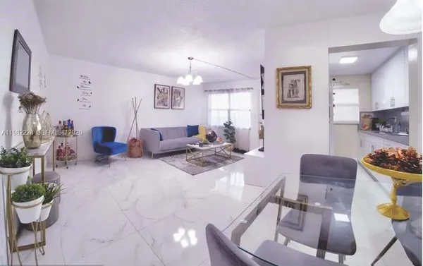 a living room with furniture and a dining room