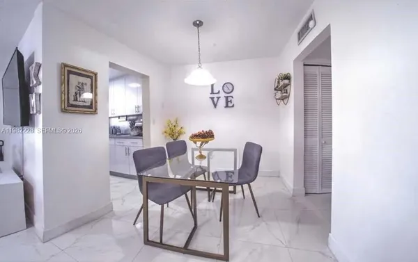 a dining room with furniture and window