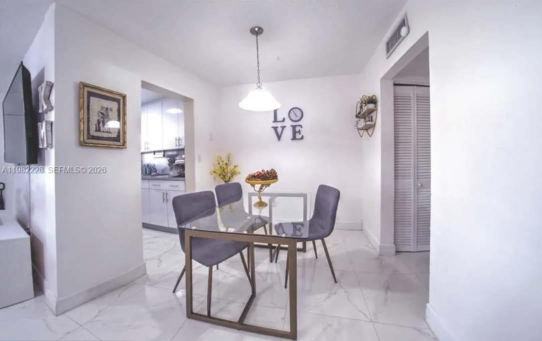 1325 West 68th Street, Unit 113 Hialeah, FL 33014 - Photo 7 of 14 a dining room with furniture and window