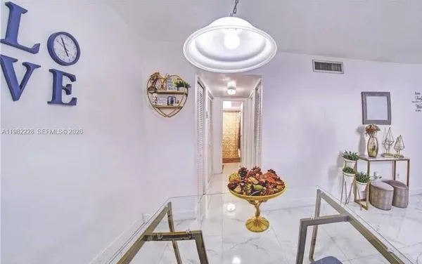 a view of dining area with chandelier and bathroom