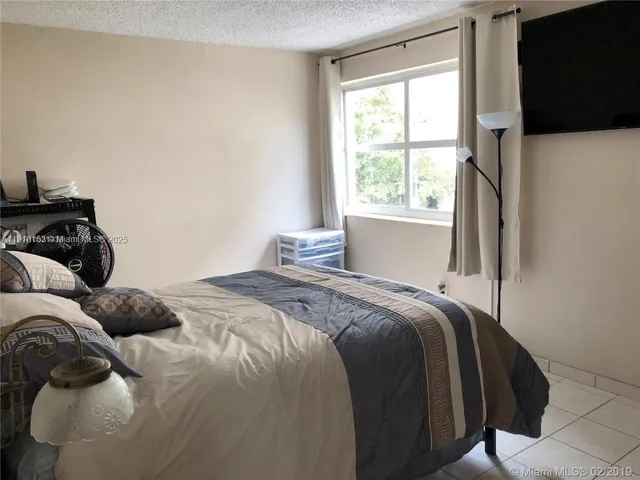 a bathroom with a sink a toilet and shower curtain