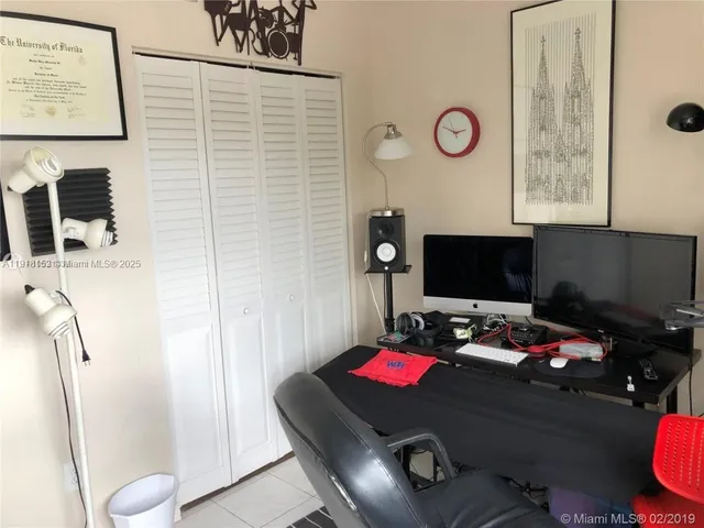 a view of a workspace with furniture and a book shelf