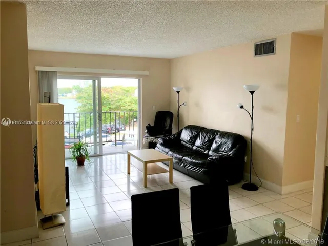 a view of a dining room with furniture and a window