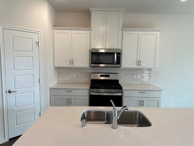 a kitchen with a refrigerator stove and a sink