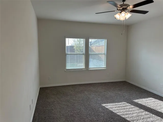 a view of a room with wooden floor and a window