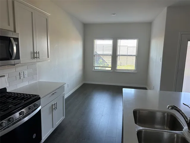 a kitchen that has a sink and a stove