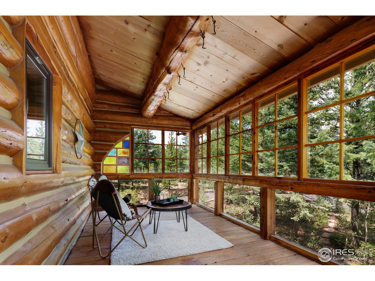 625 North Beaver Road Black Hawk, CO 80422 - Photo 8 of 40 a view of a porch with chairs and wooden floor