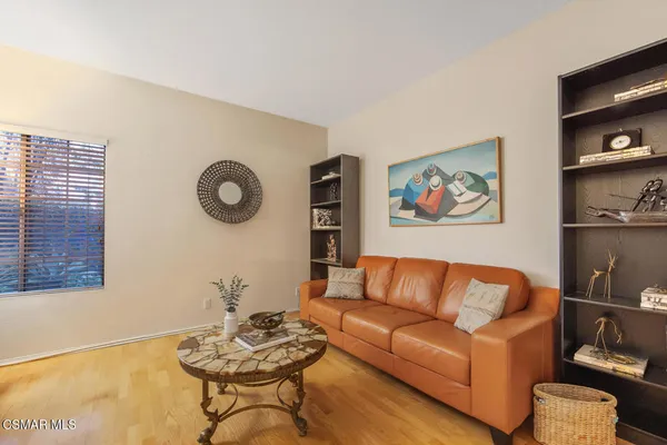 a living room with furniture and a wall painting